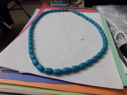 Aqua colored long oval bead necklace with lobster catch
