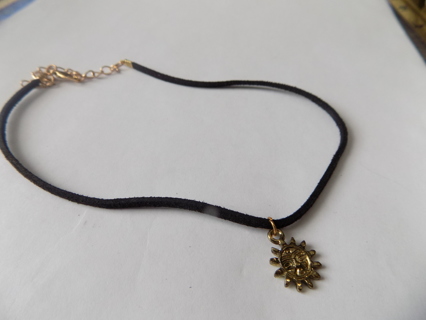 Black cord choker necklace with smiling sun charm 