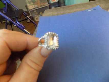 Split band ring turns into one band with clear faceted rhinesotne surrounding with small stones