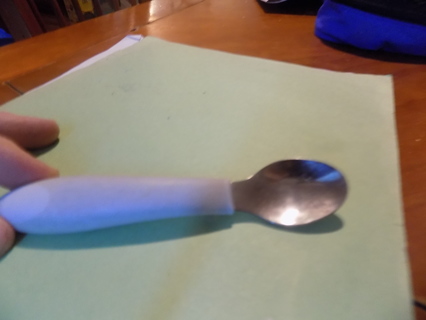 Stainless steel baby spoon with thick wide white rubber handle
