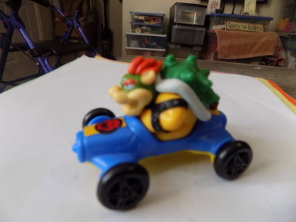 McDonalds Mario Kart green shell, red hair character in blue car