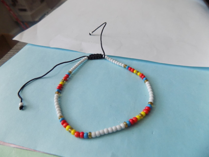 Bracelet E beads white, blue, red, yellow