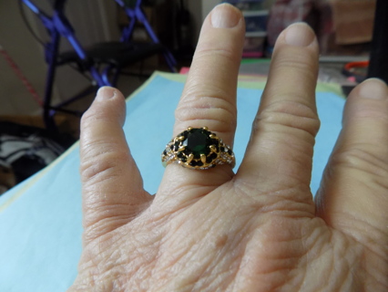 Ring # 4 goldtone sz 8 1/2 emerald green stones & clear stones around it