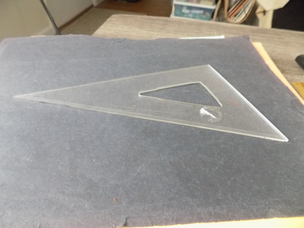 Clear acrylic triangle shape drafters tool to make straight lines