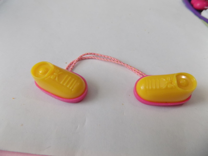 Pink and yellow doll shoe shaped pony tail holders