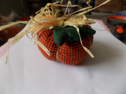 3 inch round # 2 orange and black checkered pattern pumpkin, wood stem material leaf, raffia