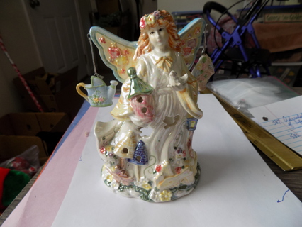 Vintage 6 1/2 inch tall glossy porcelan angel tea light holder has garden sprinkler, flowers  wing