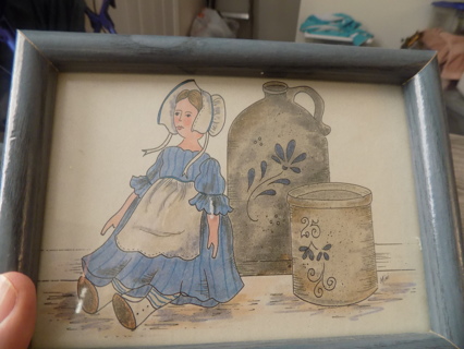 Blue wood framed wallhanging Amish doll, 2 stoneware jugs, canister 8 x 5 1/2 under glass