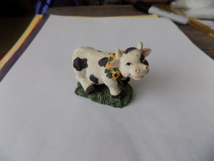 2 1/2 inch white and black spotted cow with sunflower wreath on neck