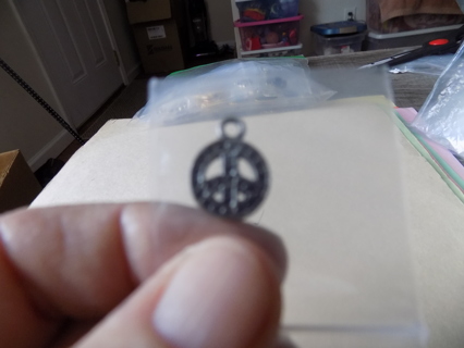 Textured peace sign inside a circle charm