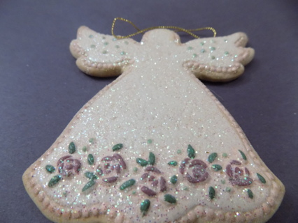 5 inch sparkly angel ornament with painted on it and rose trim bottom