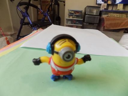 Minion in blue headphones, red and white shirt, roller skates