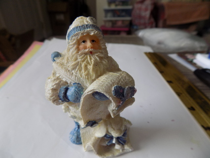 4 inch tall resin Santa dressed in blue checking his list