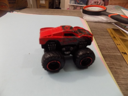 red 2 1/2 inch long Monster truck red rim tires says 60 on roof