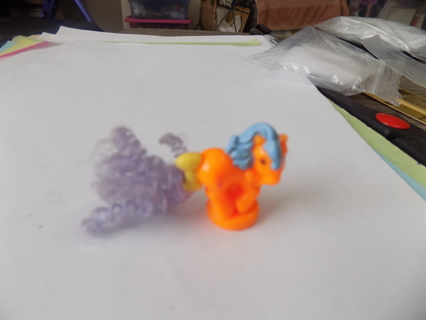 1 1/2 inch orange unicorn with fuzzy purple tail and blue mane