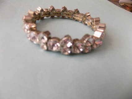 Bracelet 1/2 inch wide covered in large and small rhinestones on stretchy cord