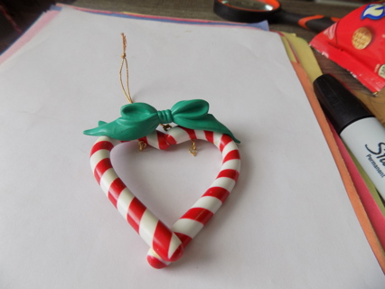 Resin candy cane heart shape ornament with green bow