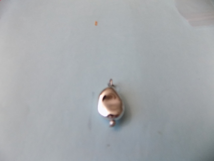 Silvertone solid dented oval charm 1 inch with small bead at bottom