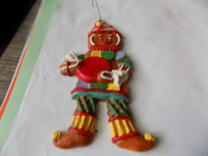 5 inch gingerbread ornament red &l white hat, holds red wrapper candy, has necklace