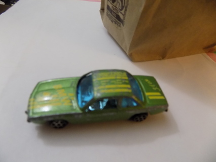 Diecast metal metallic green car with BMW on hood and race stripes