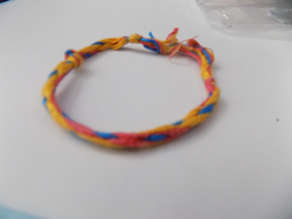 Home made woven thread friendship bracelet red, blue, yellow