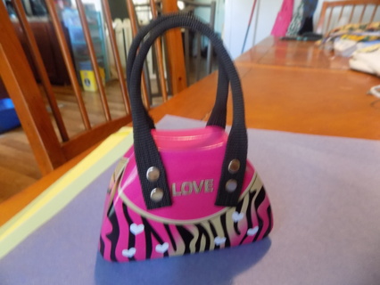 Pink metal mini zebra striped purse says LOVE and has white dots painted on it