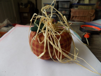 3 inch round # 8 rust and tan checkered pumkin, fabric leaf, wood stem, raffia