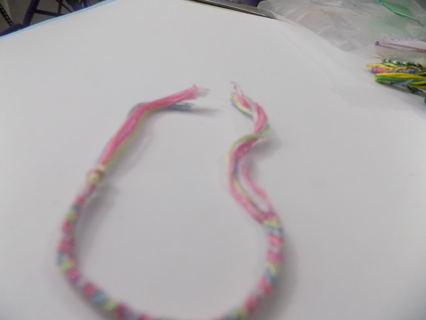 Home made child's woven Friendship bracelet thread pastel pink,blue yellow purple