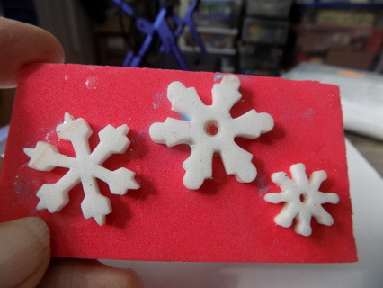 3 small each different white foam snowflakes, red background