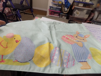 Cloth Easter Placemat 17 x 14 Has Easter Bunny in blue stripe pants carrying egg, chick, & more eggs