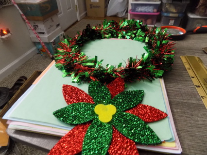 11 inch round red and green garland wreath with glittery poinsetta dangle