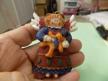 3 inch resin angel holds gingerbread boy dressed in blue and red dress