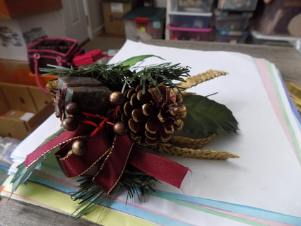 Christmas pick wrapped present,gold edge painted pinecones maroon ribbon, greenery