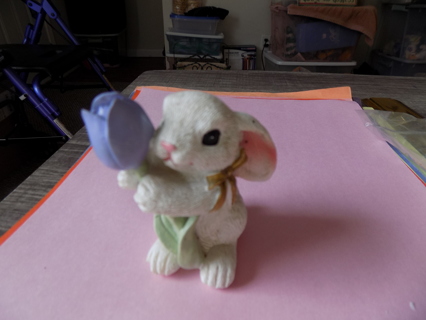 3 inch tall white resin bunny holds a purple tulip