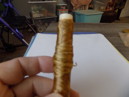 Roll of gold waxed cord for making jewelry