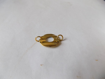 Goldtone ripple circle charm with cut out hole in middle link on both sides