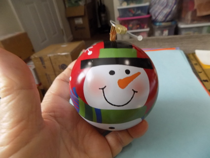 3 inch metal ball ornament with snowman painted on opens to fill with surprise