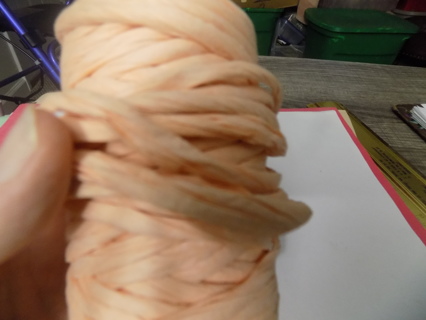 Peach color twisted paper roll partially used