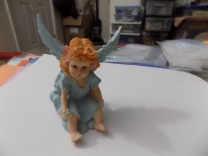 2 1/2 inch tall little angel dressed in blue in sitting pose