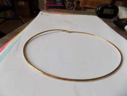 Goldtone serpentine choker style necklace with lobster catch