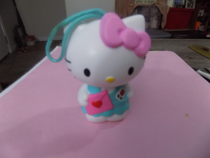 2 1/2 inch hard plastic Hello Kitty in blue dress pink bow in hair ornament