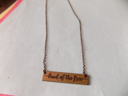 Necklace brass chain and bar charm says Land of the Free