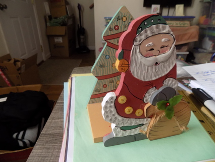 hand made 7 inch wooden Santa with toy bag book holder  decorated tree background