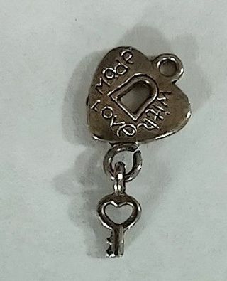 One new silvertone made with love heart with hanging key lock charm