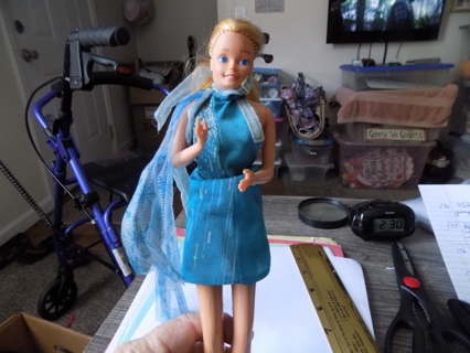 Vintage Barbie Doll in blue dress with light blue long sash, blonde hair ponytail