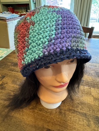 Qty of 1 Crocheted Hats. Colors are Navy Blue, Purple, Green, Red, etc.