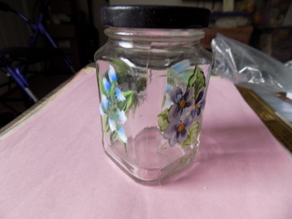 4 inch tall square glass jar with purple flowers painted on all 4 sides Twist off lid signed by arti