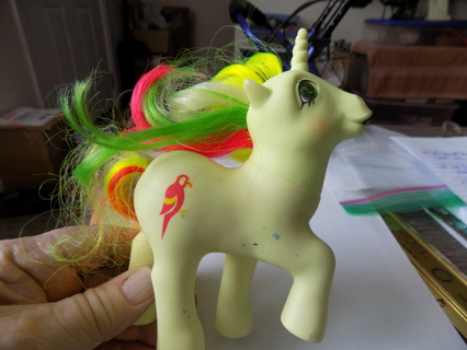 My Little Pony yellow unicorn with yellow green red white mane & parrot on hip