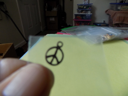 All brass peace sign inside a circle charm