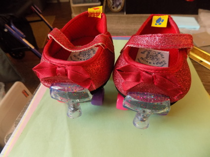 Build a bear workshop pair of red glittery roller skates with different color wheels bow on front